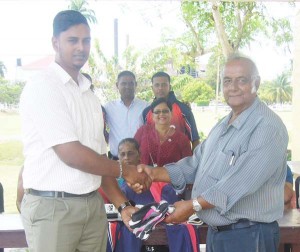 Mr. George Baijnauth (right) presented the gear to Mr Ramesh Dedicharran as others, some wearing the uniforms, enjoy the moment. 