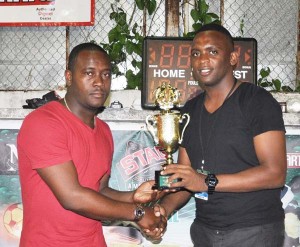 Managing Director of Office Pro, Designs and Office Supplies, Stephen Greaves (left) hand over a trophy to NEE Director, Aubrey Major Jr. in Linden.