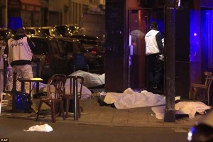 Victims lay on the pavement outside Paris restaurant following a terror attack in the French capital tonight.