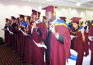 Best Graduating Student Nigerian Chinedu Joseph Asigebu and other doctors take the Hippocratic Oath at graduation. 