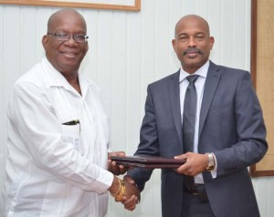 Minister of Finance, Winston Jordan and CEO of CARICOM Development Fund, Rodinald Soomer, at the signing yesterday. 