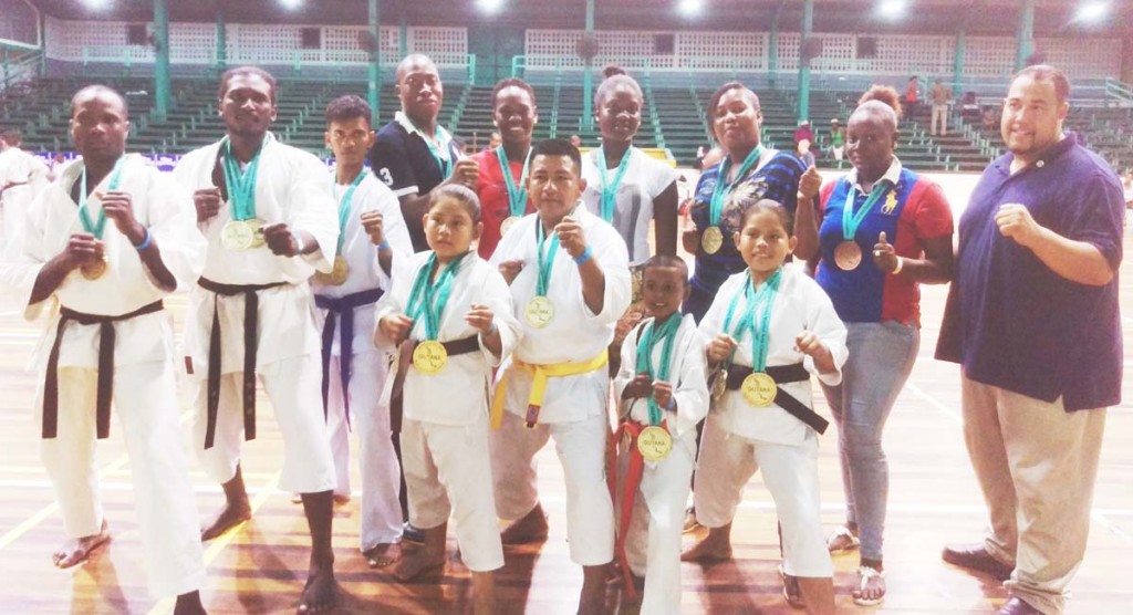  Sensei Bobb (extreme left) interacts with his students and another organizer, Jose Torres, shortly after the tournament ended.