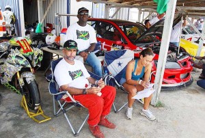 Jamaica’s Peter ‘Zoom Zoom’ Rae (left) relaxes with members of Team Jamaica during a CMRC Meet at the South Dakota Circuit.
