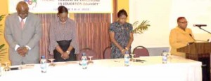 From left: Chief Education Officer, Olato Sam, Minister Nicolette Henry, NCERD Director, Ms Jennifer Cumberbatch and chairperson of the symposium, Ms Marcia Thomas observing a moment of silence.