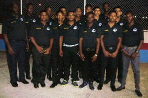 The GTC/PM Alimni Squad all decked out in their travelling uniform on their way to participate in the tournament. Coch Levi Nedd is at left with manager Gregory Rambarran is at right. 