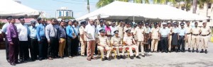 COP Persaud (seated centre) and two other high-ranking officers pose for a photo with recipients of awards yesterday.