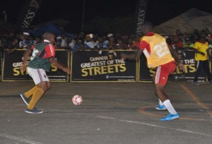 Back Circle’s Andy Duke attempts to dribble past a player from Channel 9 Warriors in their clash on Tuesday evening at the National Cultural Centre Tarmac.