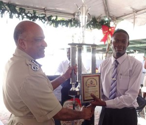 Best CID Detective 2015, Sergeant Rodwell Sarrabo receives his awards from Police Commissioner Seelall Persaud DSM. 