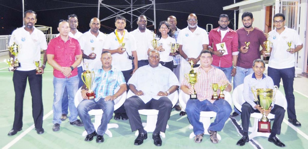  Guyana NRA President Brigadier Mark Phillips (seated 2nd left) flanked by A-Class champ Dr. Johan Da Silva (2nd right), B-Class winner John Ferreira (left) and Hemant Narine (9mm winner) along with other awardees following the presentation. 