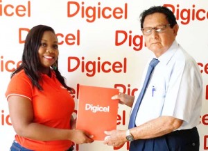 Sponsorship Executive Louanna Abrams hands over the sponsorship to President of the Kennard’s Memorial Turf Club, Cecil Kennard yesterday, at Digicel’s Head Office.