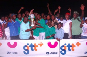 GTT’s Representative Eusi Francis hands over the winning trophy to a member of the victorious Milerock team in the presence of teammates and supporters on Sunday.
