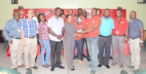 Ministry of Tourism PRO Marjorie Chester hands over first prize to Banks DIH team Captain Seon McKenzie.