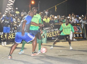 Sparta Boss’s Denis Edwards (backing camera) is closely watched by North Ruimveldt’s Solomon Austin during their encounter on Tuesday.