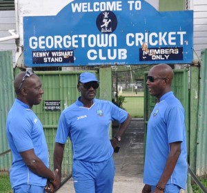  Vasbert Drakes (right), Ezra Mosley and Cuban Hector Charles in discussion outside Bourda yesterday.    