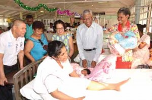 President David Granger, First Lady, Mrs. Sandra Granger, Minister of Health, Dr. George Norton and Minister of Social Cohesion, Ms. Amna Ally enjoying their time with this new mother, during the tour of the maternity ward at GPHC on Christmas Day