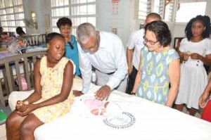 President Granger meeting Christmas baby Tatianna, as First Lady Sandra Granger, Minister Amna Ally, Staff Nurse Michelle Holder and the baby’s mother, Venetia look on.