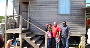 In picture, former President Donald Ramotar and former Housing Minister Irfaan Ali, with one of the beneficiaries.