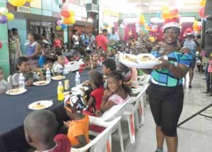 This charming lady brings out the smiles on the children’s faces as she serves them