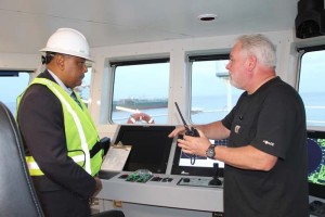 Minister Raphael Trotman listens to the Captain of the Fugro Americas.