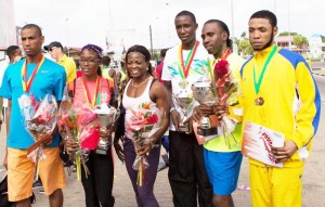 Guyanese Glory! Guyanese and other athletes display their silverware, from left, Lionel D’Andrade, Andrea Foster, Alisha Fortune (Foster’s mom), Cleveland Thomas is second right.