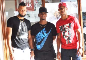 Reyad Emrit (right), Lendl Simmons (middle) and Nicholas Pooran at the Digical shop at the CJIA shortly after they arrived in Guyana.