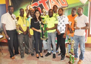 Ansa McAl Public Relations Officer Ms. Darshanie presents the trophy to Grove Hi-Tech Captain Shermon Doris in the presence of individual winners and team representatives.