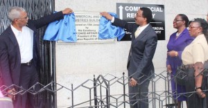 The unveiling of the plaque by President David Granger (Left) and the Attorney General and Minster of Legal Affairs, Basil Williams. 