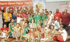 Kwakwani’s male and female basketball teams along with Coach, Ann Gordon (right) celebrate their dominance at the 2015 National Schools’ Basketball Festival.