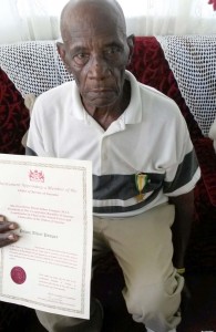 Prince Albert Pompey with his Golden Arrow of Achievement medal and certificate, for long and dedicated service in the field of local government and politics. 