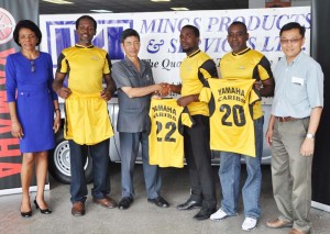 Mings Products & Services Technical Director Colin Ming (3rd left) hands over one of the uniforms to Club Captain Akeem Fraser in the presence of Company officials (Audrey Ford (left), John Chin (right) and club executives Robin Roberts (2nd right) and Walter George (2nd left) yesterday.