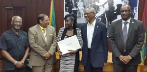 Newly Sworn-in Minister within the Ministry of Communities (with responsibility for Housing), Valerie Adams-Patterson (centre) shares the moment with Prime Minister Moses Nagamootoo in the presence of President David Granger, as well as Minister Joseph Harmon (far right) and Minister Keith Scott (far left).