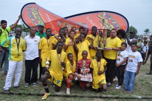 Marketing and Sales Manager of Continental Agencies Limited Mr. Avalon Jagnandan (5th right) hands over the champions trophy to Grove Hi Tech Captain Denzil Crawford as his teammates and club officials savor the moment. 