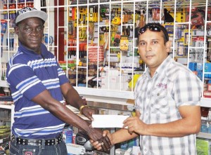 CEO of Target Hardware and General Store Troy Baksh (right) presents the cheque to Mark Wiltshire. 