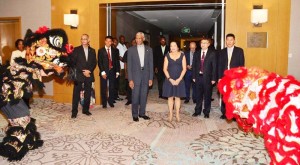 President David Granger and First Lady Mrs. Sandra Granger are welcomed by Chinese dancers performing the Dragon Dance.