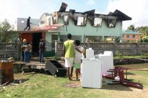 Fire victims stand among the items they managed to save 