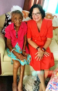 Centenarian Edmay Mc Intosh shares a moment with First Lady Sandra Granger 