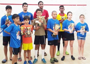 The respective winners of the Bounty Farm Handicap Squash tournament display their trophies. 