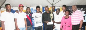 Bulls players with Banks DIH Co-Chairman and Managing Director McDonald (right) and Linden Branch Manager Ms. Shondel Easton (2nd right) at the presentation. 