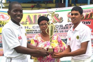 Captains of the winnings teams, Berbice High School (left) Malcolm Mickle and Rosignol Secondary Chandradat Veerasammy proudly display their trophy in the presence of BCB representative Angela Haniff. 