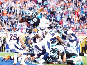 Carolina Panthers running back Jonathan Stewart (28) dives over the pile of defenders for a touchdown.  Mark J. Rebilas, USA TODAY Sports