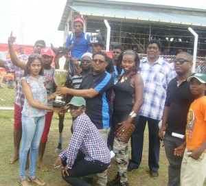 Connections of the Shariff stable collects the winning trophy in the three year event.