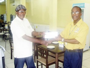 Courts Berbice Branch Manager Stanley Alexander (right) presents the entity’s sponsorship cheque to FACC coach and organiser Randolph Roberts. 