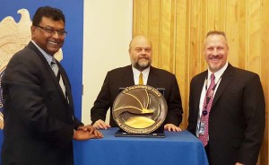 Historical drug fight moment: Public Security minister Khemraj Ramjattan, US ambassador Parry Holloway and Matthew Donahue share a photographic moment after unveiling the DEA Emblem in the US Embassy.  