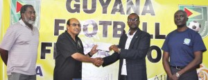 GOA President K. A Juman Yassin (2nd left) hands over the cheque to GFF President Wayne Forde in the presence of GOA Secretary Hector Edwards (left) and Ian Alves. 