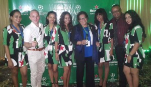 Ansa McAl Trading Ltd. Managing Director, Beverly Harper (fourth, right), Marketing Director, Troy Cadogan (second, right) and Heineken Brand Manager, Robert Hiscock (second, left) take a photo opportunity with models Tuesday at the Pegasus Hotel.