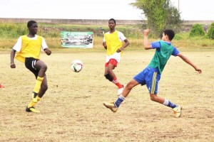 - Part of the action in the clash between eventual South Ruimveldt (green bibs) and Central High yesterday, at the Ministry of Education ground.
