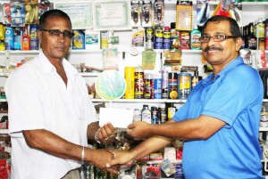 Mr. Chand Hardyal A.K.A Vishnu, Proprietor of Vishnu’s Super Store hands over the sponsorship to UCCA President Mr. Dennis De Andrade.