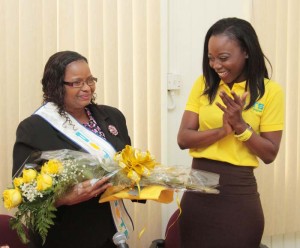 Minister Lawrence receives a bouquet of flowers from Lisa Punch
