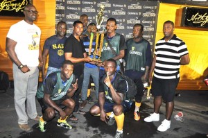 Banks DIH representative Tony Ramcharran (3rd left) hands over the first prize money and trophy to Showstoppers Captain Marvin Josiah in the presence of Guinness Brand Manager Lee Baptiste (left), Outdoor Events Manager Mortimer Stewart (right) and teammates.