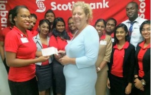 Scotiabank CRCU staff, Candacy Nixon presents the cheque to Jessica Hatfield, Patron of the RCAC in the presence of the Scotiabank CRCU Team